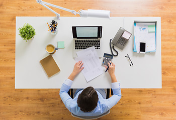 Image showing businesswoman with tax report at office