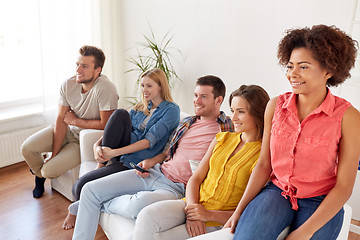 Image showing happy friends with remote watching tv at home