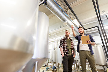 Image showing men with clipboard at brewery or beer plant