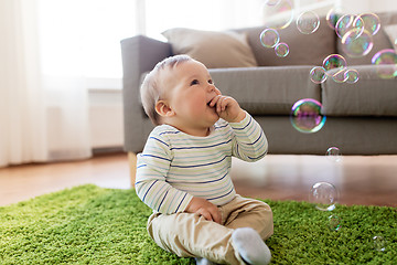 Image showing baby boy playing with soap bubbles at home