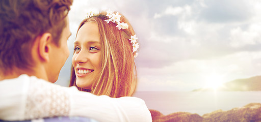 Image showing happy smiling young hippie couple over sea