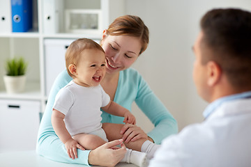 Image showing happy woman with baby and doctor at clinic