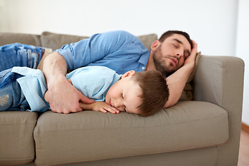 Image showing happy father and son sleeping on sofa at home