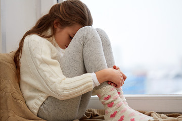 Image showing beautiful sad girl at home