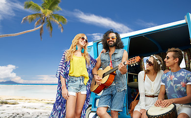 Image showing hippie friends playing music over minivan on beach