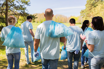 Image showing group of volunteers with garbage bags in park