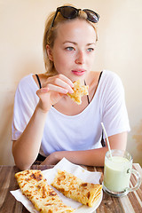 Image showing Woman eating traditional moroccan breakfast in coffee shop.