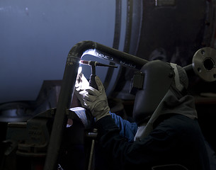 Image showing Welder working on steel pipes