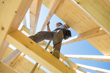 Image showing Builders at work with wooden roof construction.