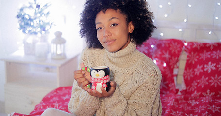 Image showing Smiling woman enjoying a cup of Christmas coffee