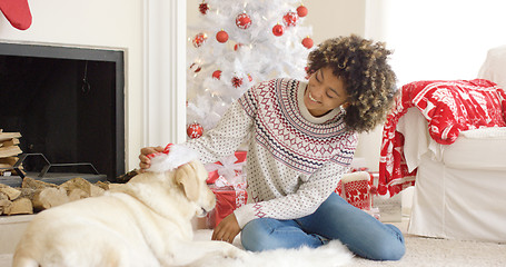 Image showing Young woman relaxing with her dog at Christmas