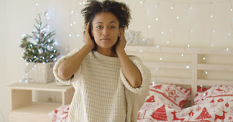 Image showing Calm young woman adusting hair in bed