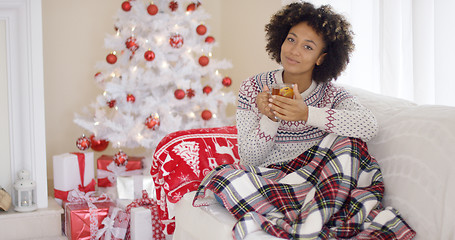 Image showing Young woman relaxing at home over Christmas