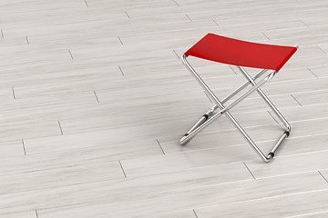 Image showing Folding stool on wooden floor