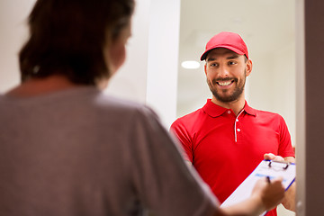 Image showing deliveryman with clipboard at customer home