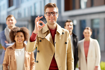 Image showing happy smiling man showing ok hand sign outdoors