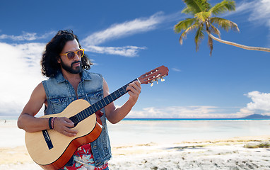 Image showing hippie man playing guitar over summer beach