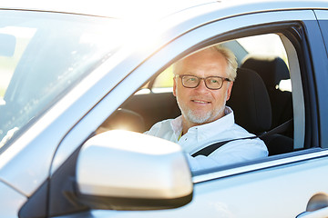 Image showing happy senior man driving car with open window