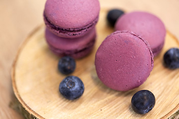 Image showing blueberry macarons on wooden stand