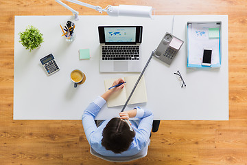 Image showing businesswoman calling on phone at office table