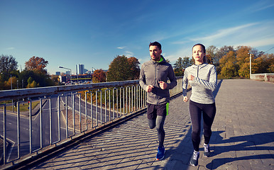 Image showing happy couple running outdoors