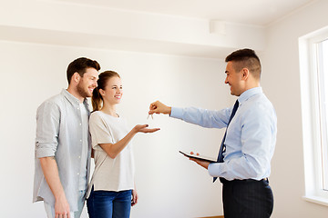 Image showing realtor giving keys from new home to happy couple