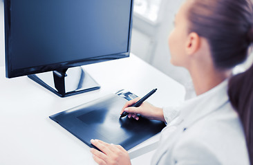 Image showing businesswoman with drawing tablet in office