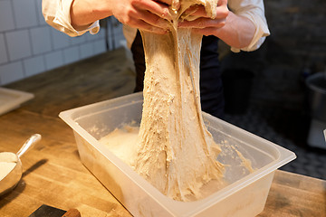 Image showing chef or baker cooking dough at bakery