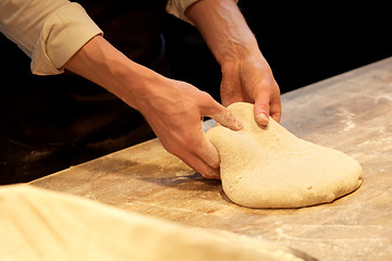 Image showing chef or baker cooking dough at bakery