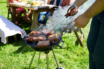 Image showing man cooking meat on barbecue grill at summer party