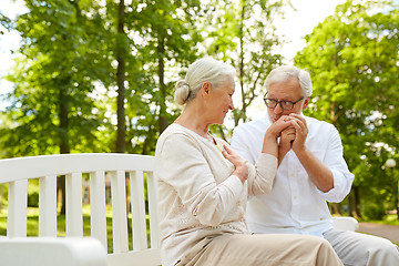 Image showing happy senior couple hugging in city park