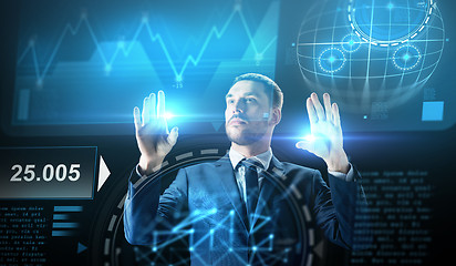 Image showing businessman working with charts on virtual screen