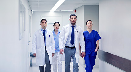 Image showing group of medics walking along hospital