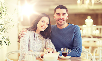 Image showing happy couple drinking tea at restaurant