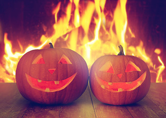 Image showing carved halloween pumpkins on table over fire