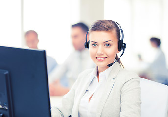 Image showing helpline operator with headphones in call centre