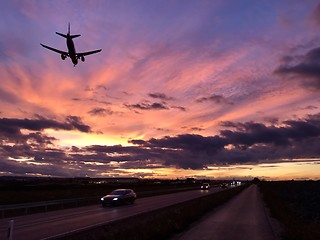 Image showing A plane is approaching Stuttgart AIrport during a dramatic sunset