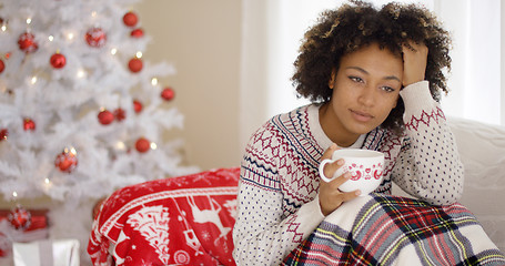 Image showing Pensive young woman celebrating a lonely Christmas