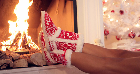 Image showing Young woman relaxing in Christmas booties