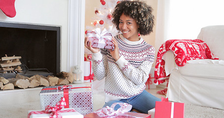 Image showing Pretty young woman checking her Christmas gifts