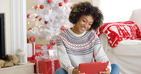 Image showing Young woman surfing the internet at Christmas