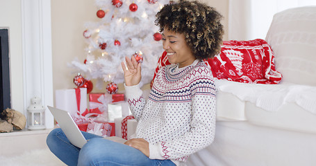 Image showing Young woman having a video chat on her laptop