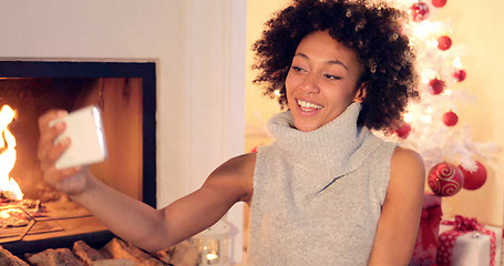 Image showing Elegant young woman taking a Christmas selfie