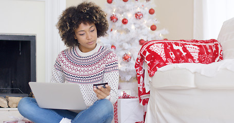 Image showing Young woman purchasing Christmas gifts online