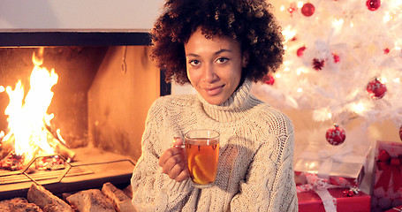 Image showing Young woman drinking spicy lemon tea