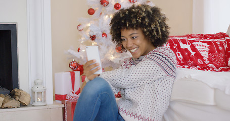 Image showing Pretty young woman video chatting on her smartphone