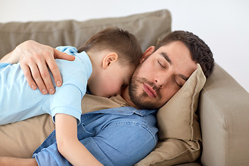 Image showing happy father and son sleeping on sofa at home