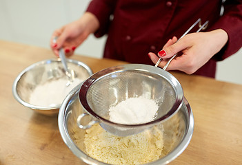 Image showing chef with flour in bowl making batter or dough