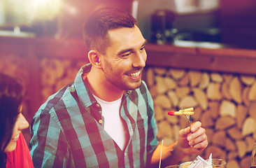 Image showing happy man having dinner at restaurant