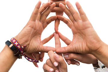 Image showing hands of hippie friends showing peace sign